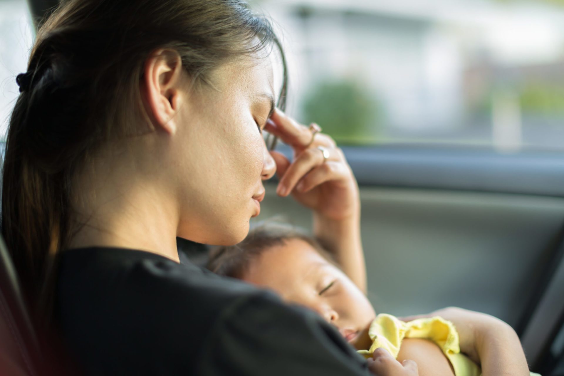 Tired stressed mother holding her baby