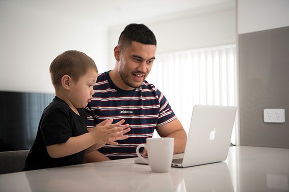 Dad and child looking at laptop