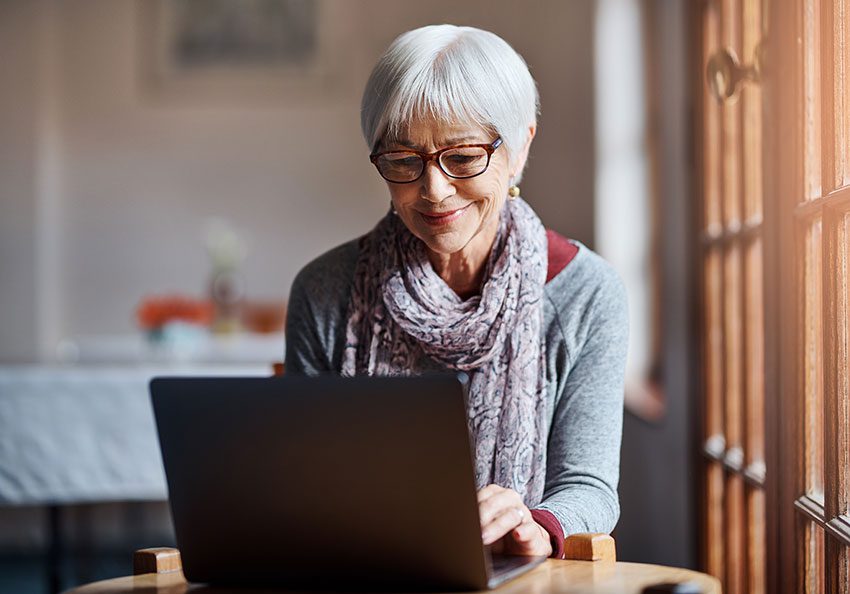 Senior woman looking at her laptop